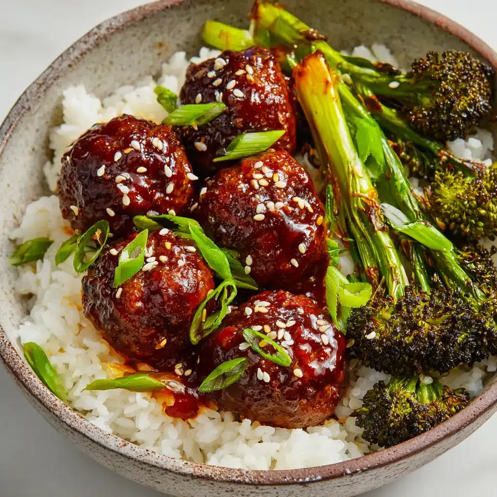 Pan-seared ground beef meatballs simmering in a thick, glossy, dark mahogany brown sticky Mongolian glaze in a cast iron skillet.