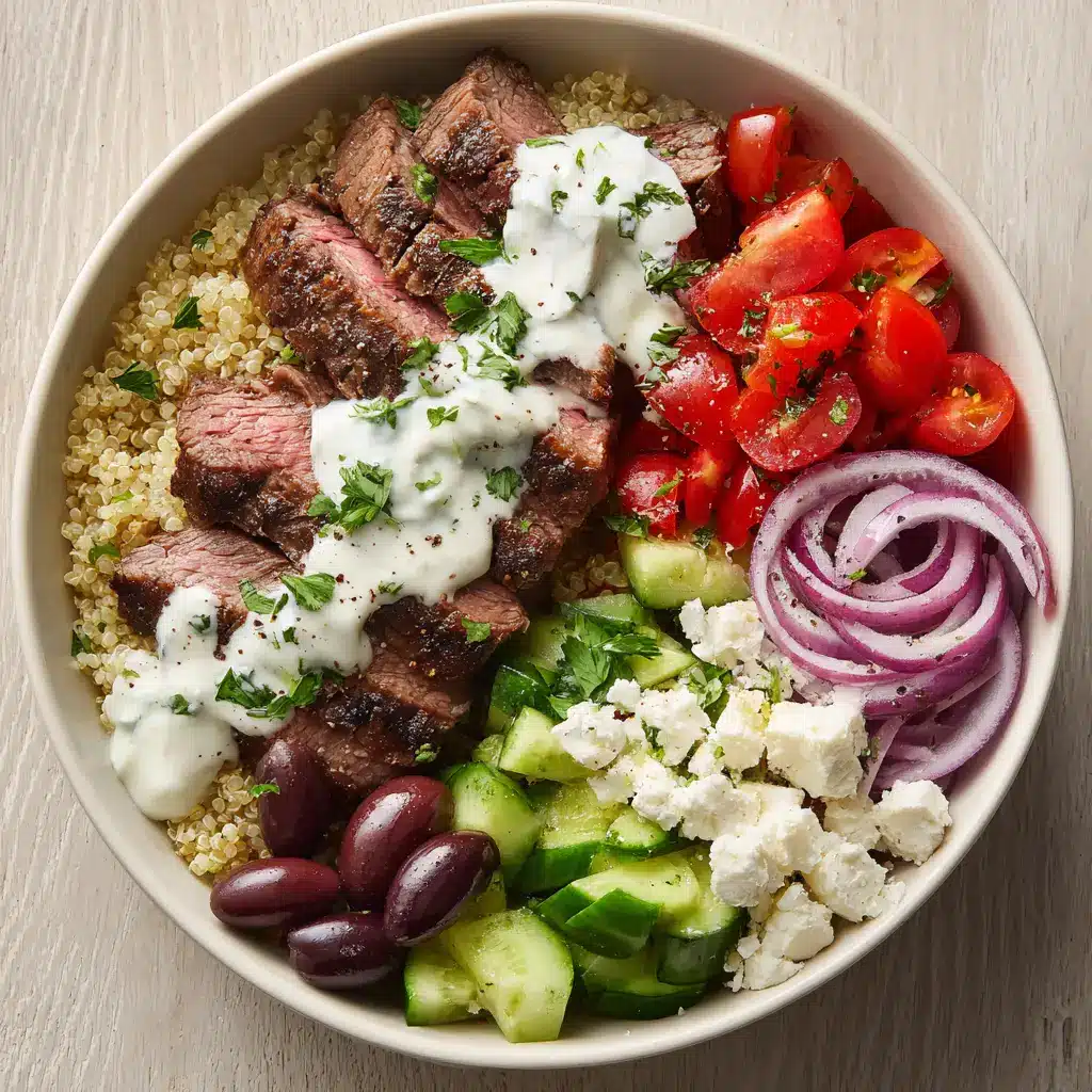 Ultimate Mediterranean Steak Bowls with Tzatziki 1 Close up photo of a Mediterranean steak bowl drizzled with creamy white tzatziki sauce, garnished with parsley and black pepper on a light wood table.
