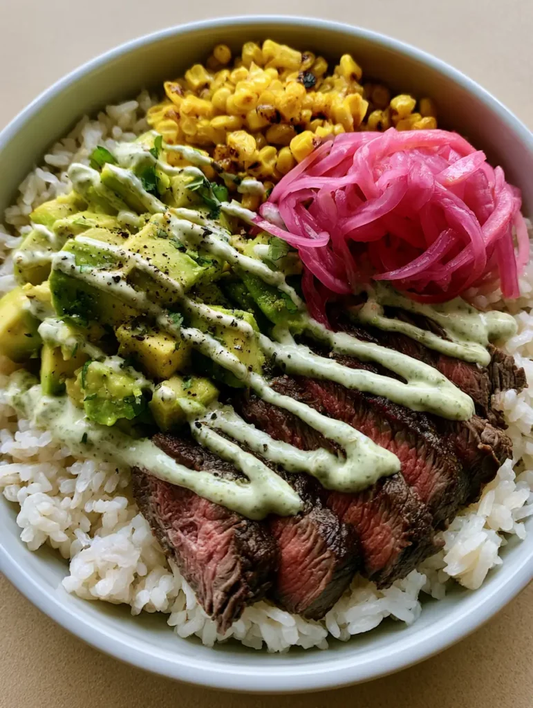 Steak and Avocado Bowl with Charred Corn and Cilantro Cream 1 Close-up of charred corn kernels and seared beef sirloin slices in a white bowl with fresh cilantro garnishes. (Steak and Avocado Bowl)